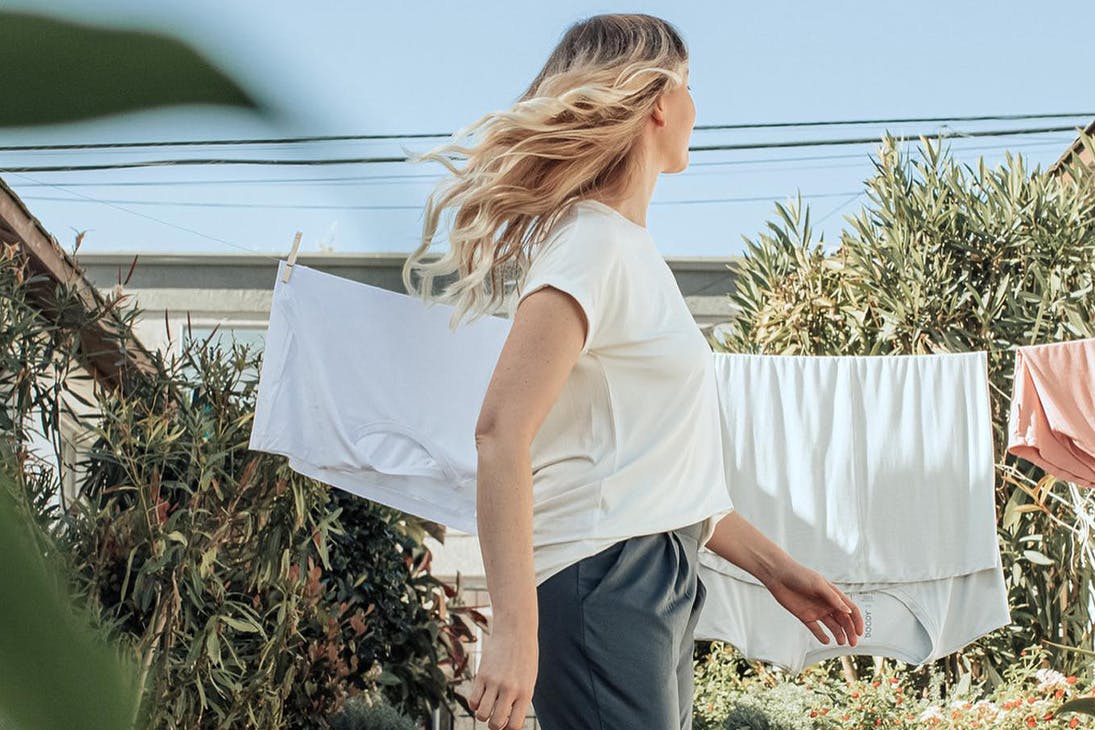 woman in a t-shirt in front of a washing line